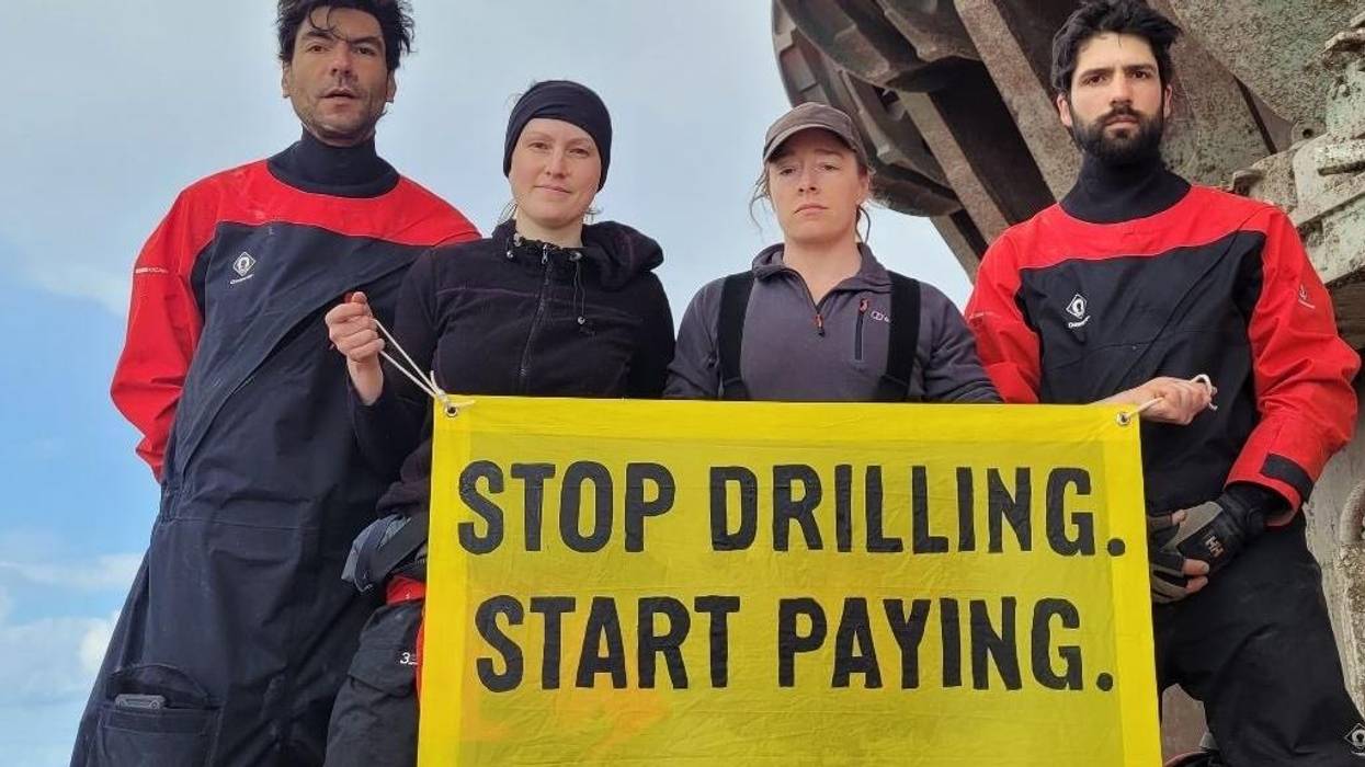 Four Greenpeace activists are pictured on a Shell vessel in the Atlantic Ocean on January 31, 2023.