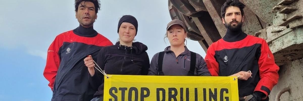 Four Greenpeace activists are pictured on a Shell vessel in the Atlantic Ocean