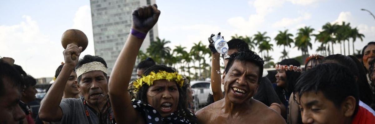 Four Indigenous Brazilians celebrate in the capital.