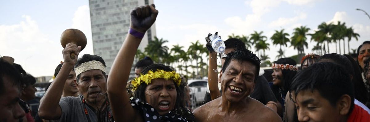 Four Indigenous Brazilians celebrate in the capital. 