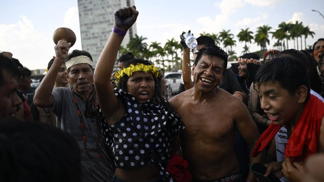 Four Indigenous Brazilians celebrate in the capital.