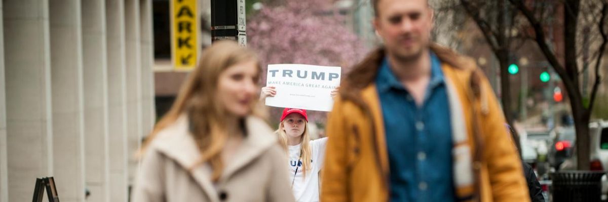 Fourteen-year-old Donald Trump supporter Jayne Zirkle holds a sign in support of her candidate