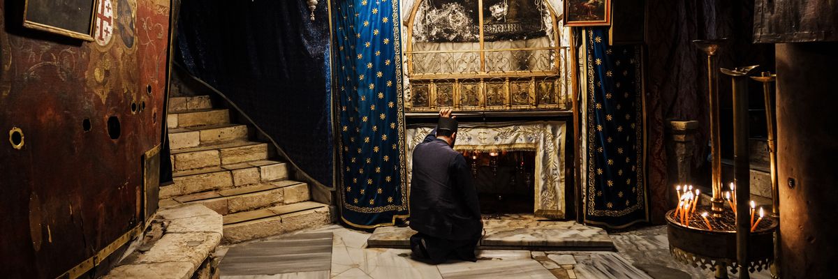 Fr. Issa Thaljieh poses in the Grotto of the  Nativity in Bethlehem, Occupied West Bank.