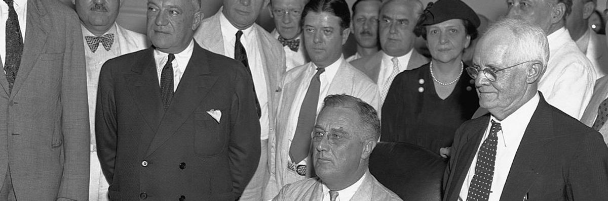 Franklin Delano Roosevelt with staff behind him