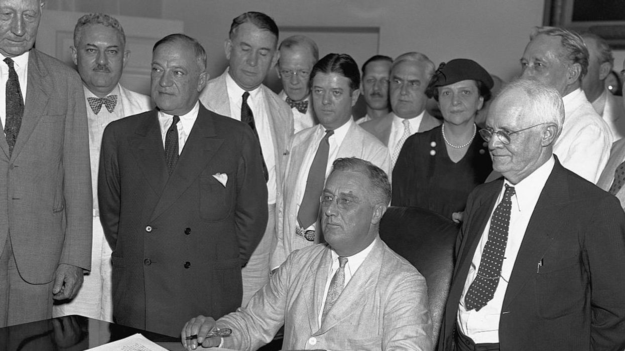 Franklin Delano Roosevelt with staff behind him