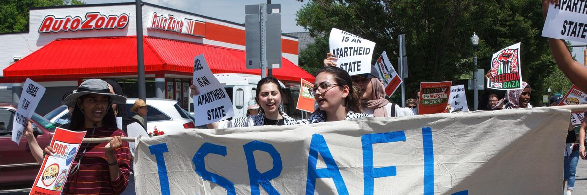 Free Palestine advocates hold a banner while marching in Columbus, Ohio.