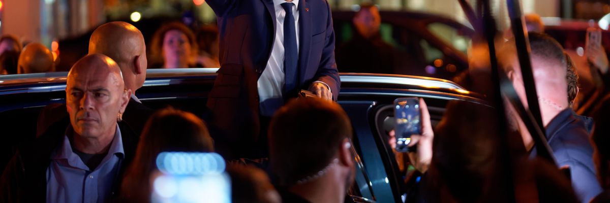 French President Emmanuel Macron waves to supporters