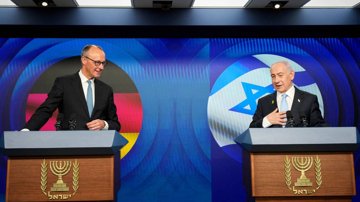 Friedrich Merz and Benjamin Netanyahu stand at podiums during a joint press conference