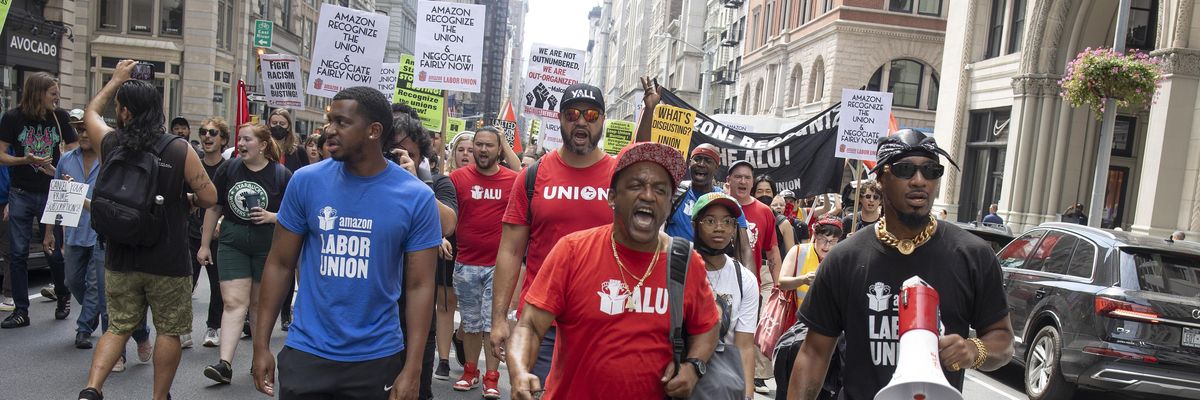 From left to right: Derrick Palmer, Gerald Bryson, and Chris Smalls of the Amazon Labor Union lead a Labor Day march on September 5, 2022 in New York City.