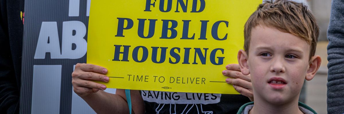 Fund Public Housing sign