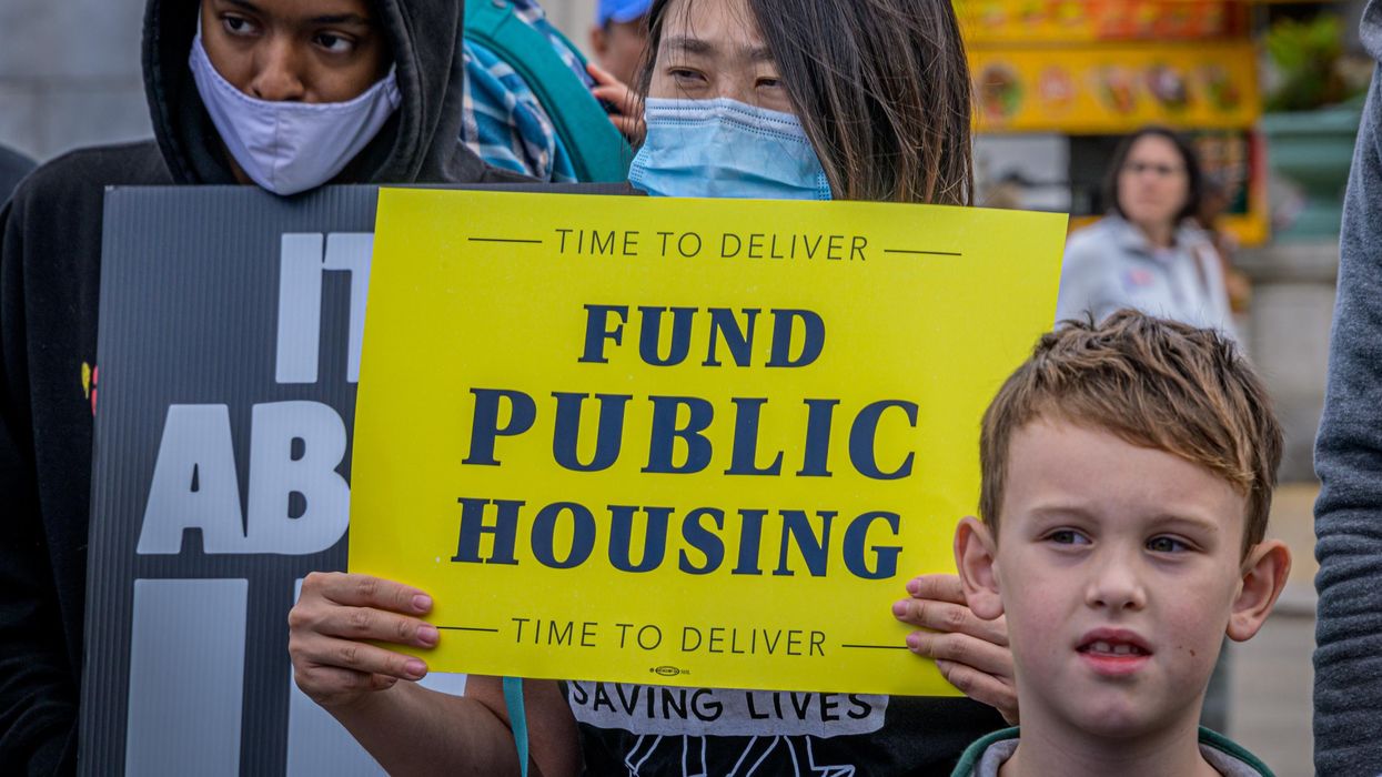Fund Public Housing sign