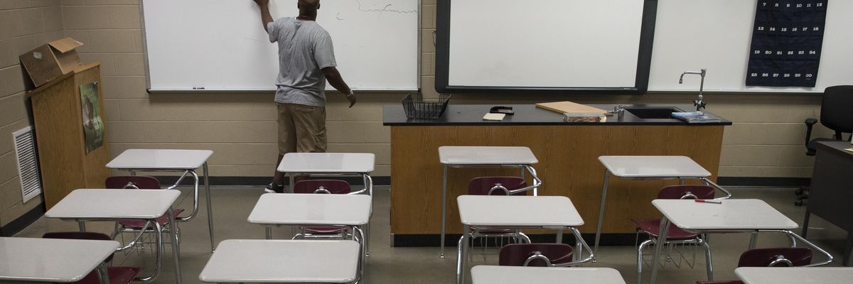 Gardendale High School biotech teacher Justin Ingram readies his classroom before the beginning of the school year in Gardendale, Alabama on August 4, 2016.