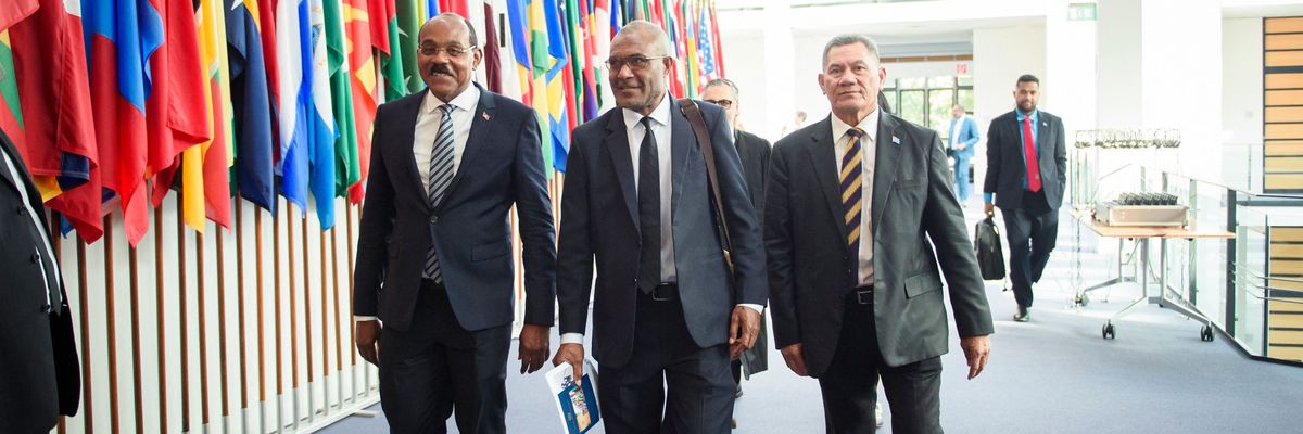 Gaston Browne (L-R), Prime Minister of Antigua and Barbuda; Arnold Loughman, Attorney General of Vanuatu; and Kausea Natano, Prime Minister of Tuvalu, walk down a hallway.