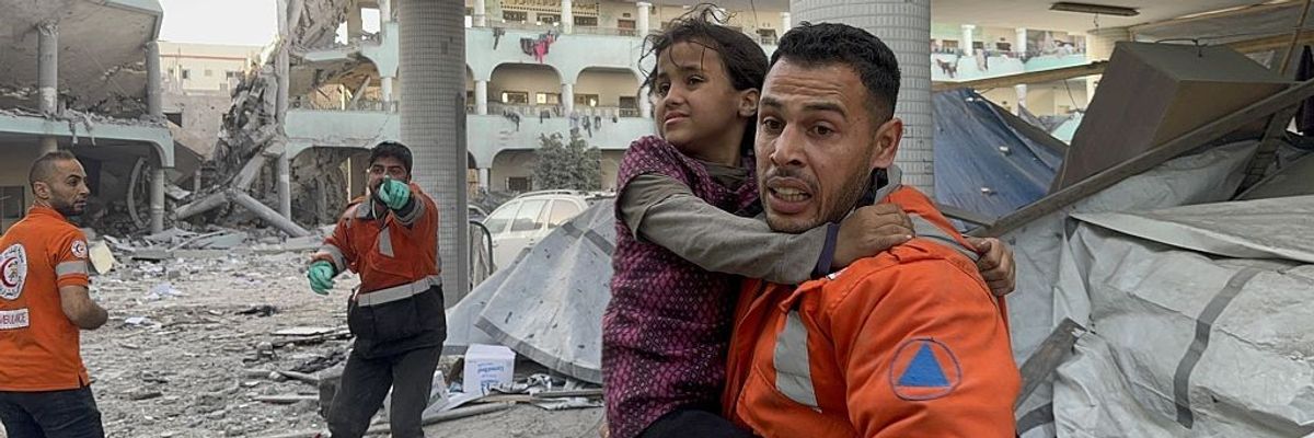 Gaza first responders rescue a girl from a bombed school