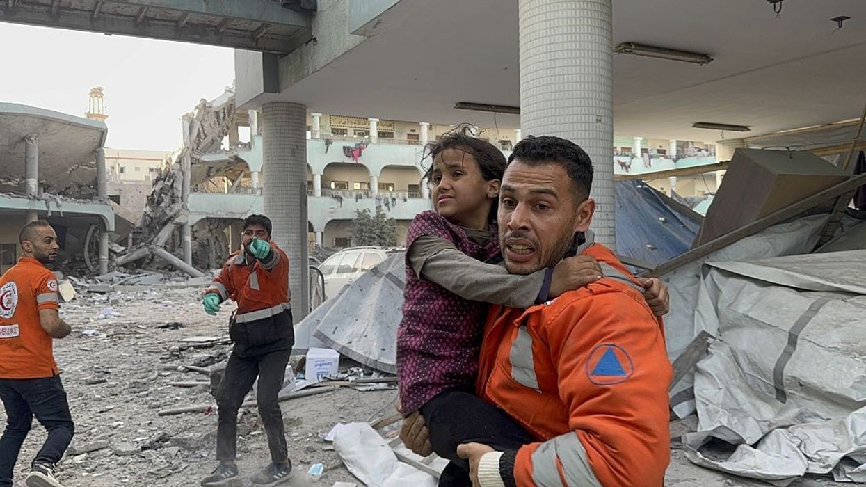 Gaza first responders rescue a girl from a bombed school