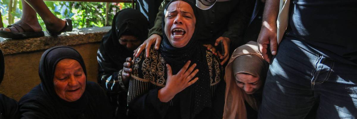 Gaza women mourn a Palestinian child killed by Israel