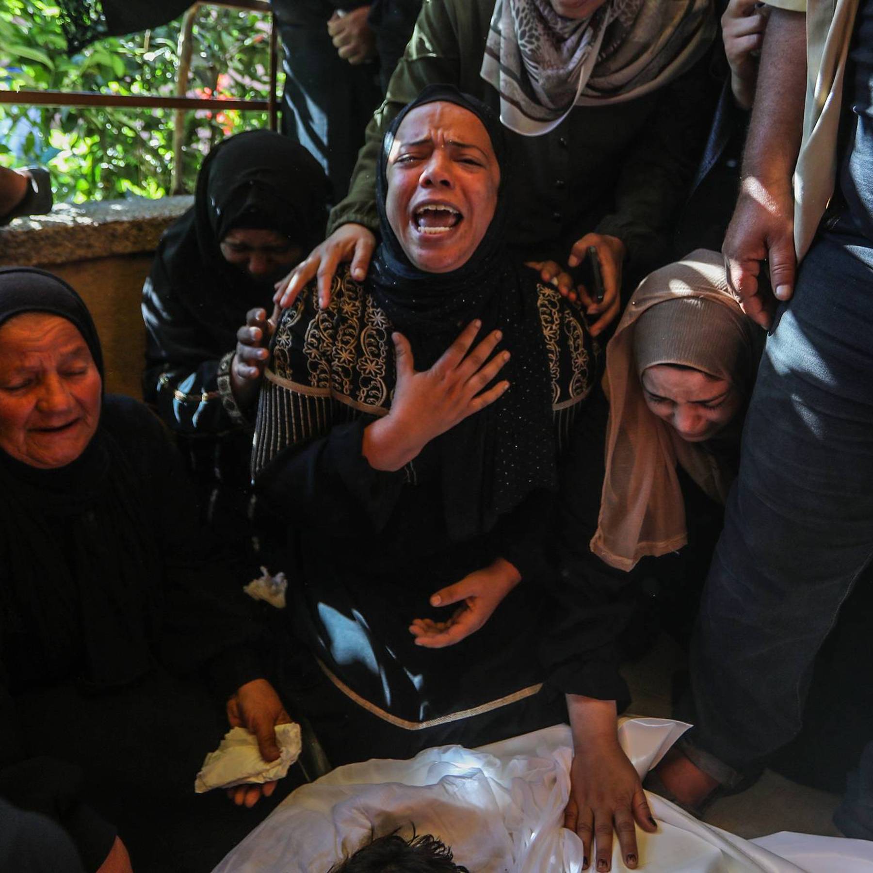 Gaza women mourn a Palestinian child killed by Israel