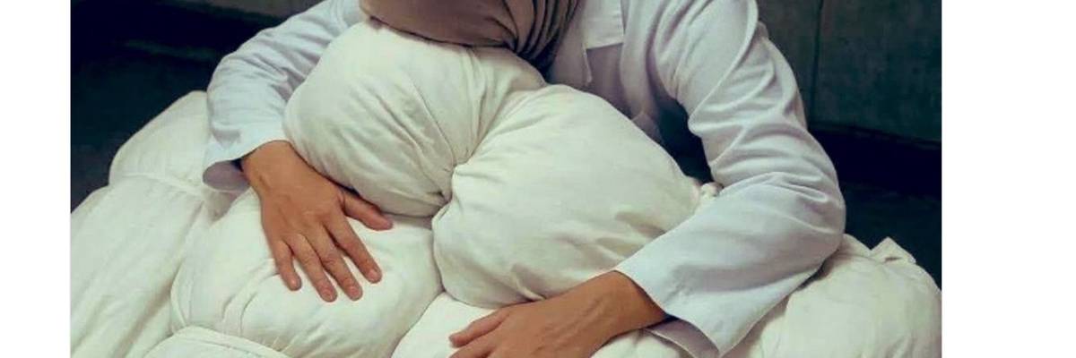 Gazan pediatrician Dr. Alaa al-Najjar grieves over the bodies of her children.