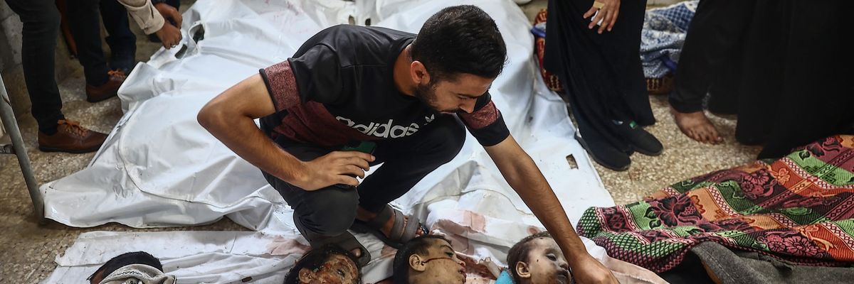 Gazans view the bodies of small victims after an Israeli air strike