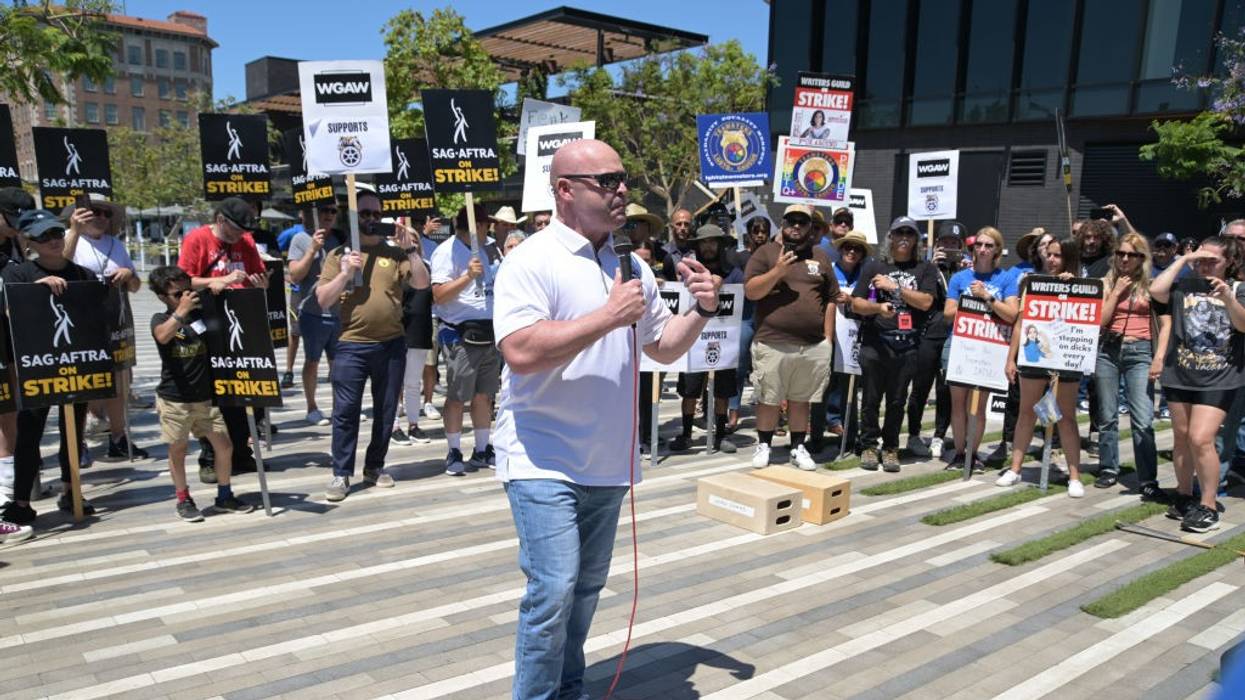 General President of the International Brotherhood of Teamsters Sean O'Brien speaks with striking workers behind him.