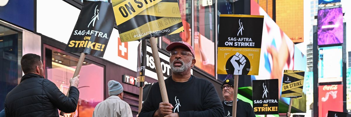 Geoffrey Owens walks a picket line
