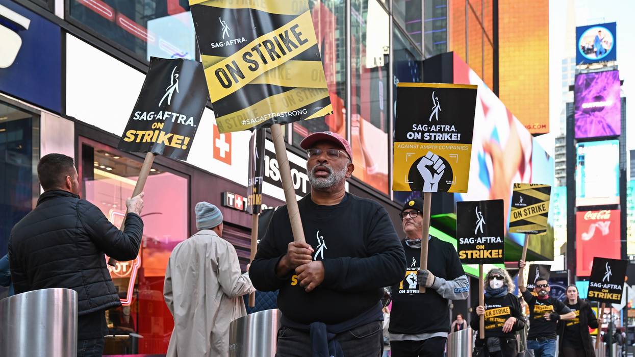 Geoffrey Owens walks a picket line