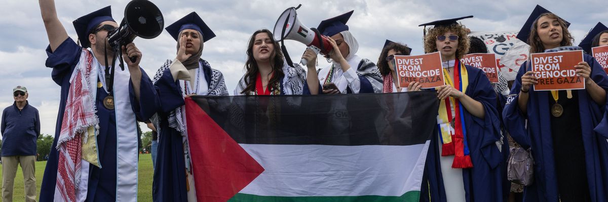 George Washington University students hold a walkout at the National Mall as the institution's president, Ellen Granberg, delivers her commencement address