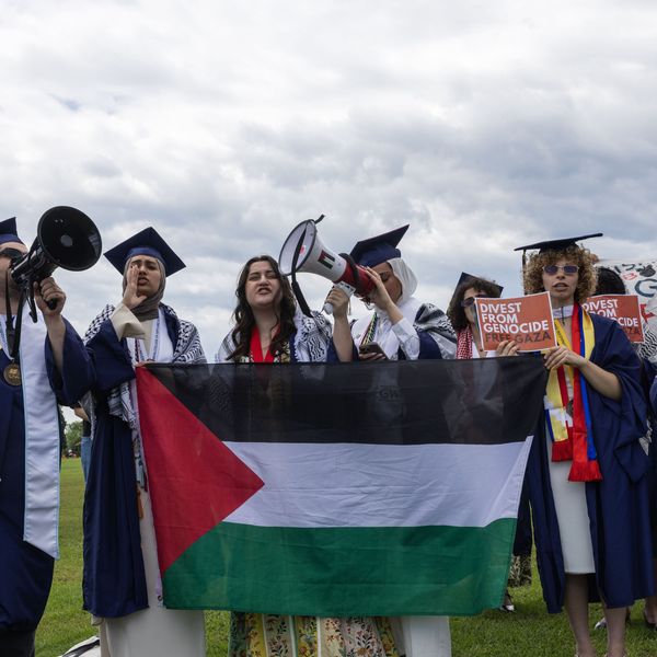George Washington University students hold a walkout at the National Mall as the institution's president, Ellen Granberg, delivers her commencement address
