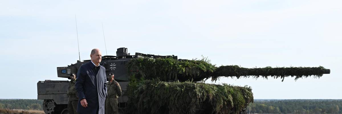 German Chancellor Olaf Scholz walks past a Leopard 2 tank