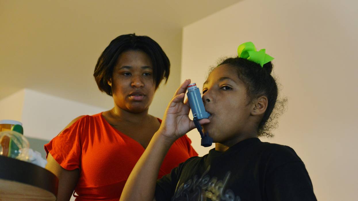 Girl with asthma takes her medication