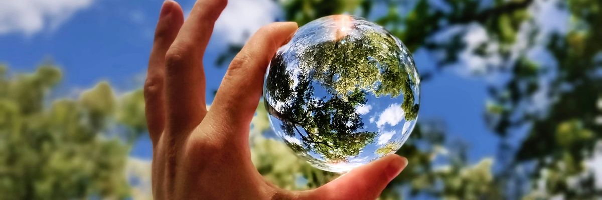 Glass ball through trees looks like planet earth