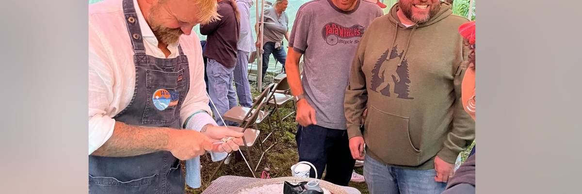 Graham Platner shucks oysters before speaking in Belmont ME