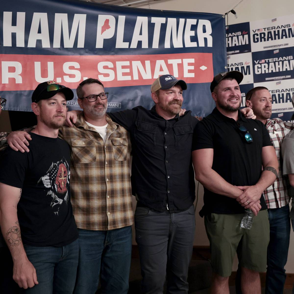 Graham Platner stands with veterans during a campaign event