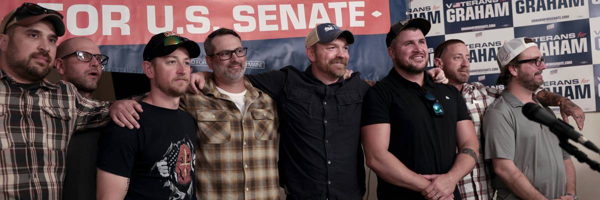 Graham Platner stands with veterans during a campaign event