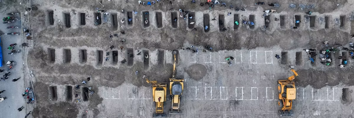 Graves dug for Iranian children killed in school bombing.