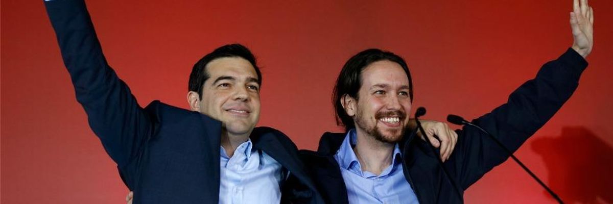 Greek opposition leader and head of radical leftist Syriza party, Alexis Tsipras (L) and Spanish Podemos party Secretary General Pablo Iglesias