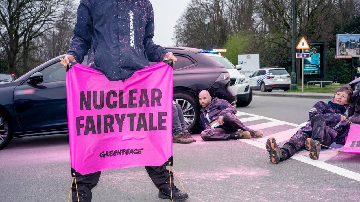 Greenpeace activist holds sign reading "Nuclear Fairy tale."