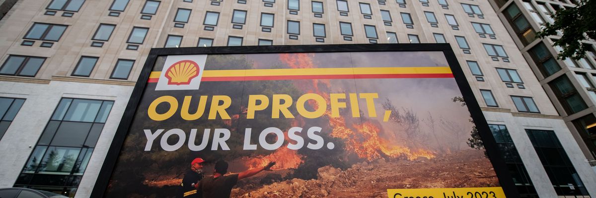 Greenpeace activists display a billboard outside Shell headquarters