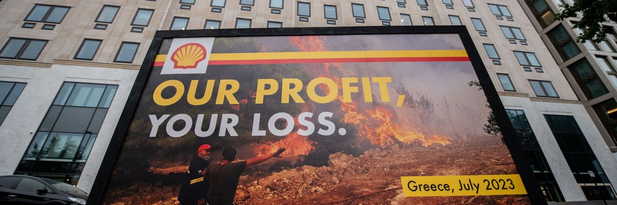 Greenpeace activists display a billboard outside Shell headquarters