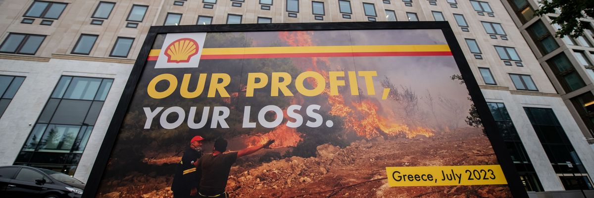 Greenpeace activists display a billboard outside Shell headquarters