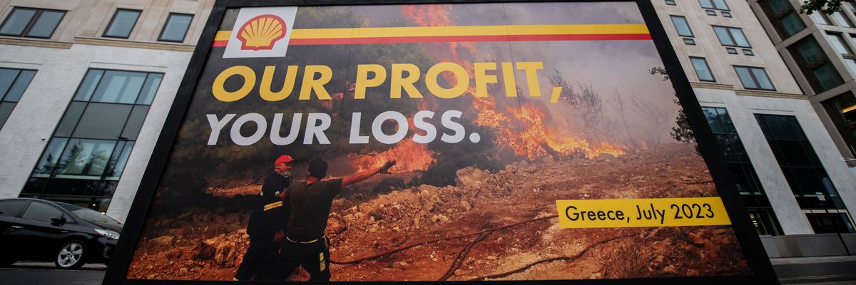 Greenpeace activists display a billboard outside Shell headquarters