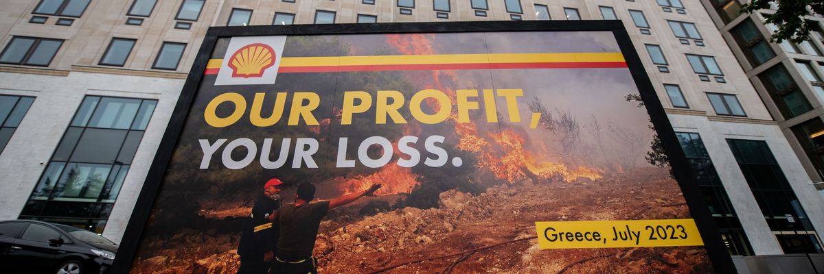 Greenpeace activists display a billboard outside Shell headquarters