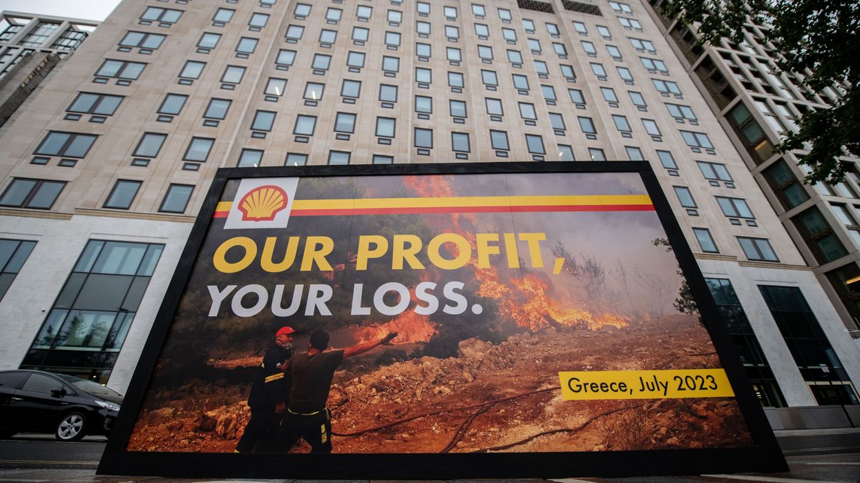 Greenpeace activists display a billboard outside Shell headquarters
