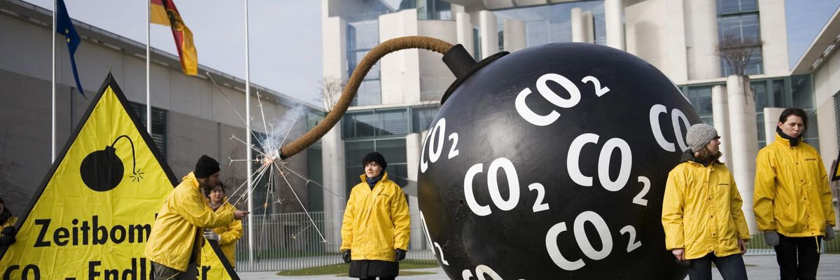 Greenpeace activists in Germany light up a mock bomb to protest carbon capture and storage