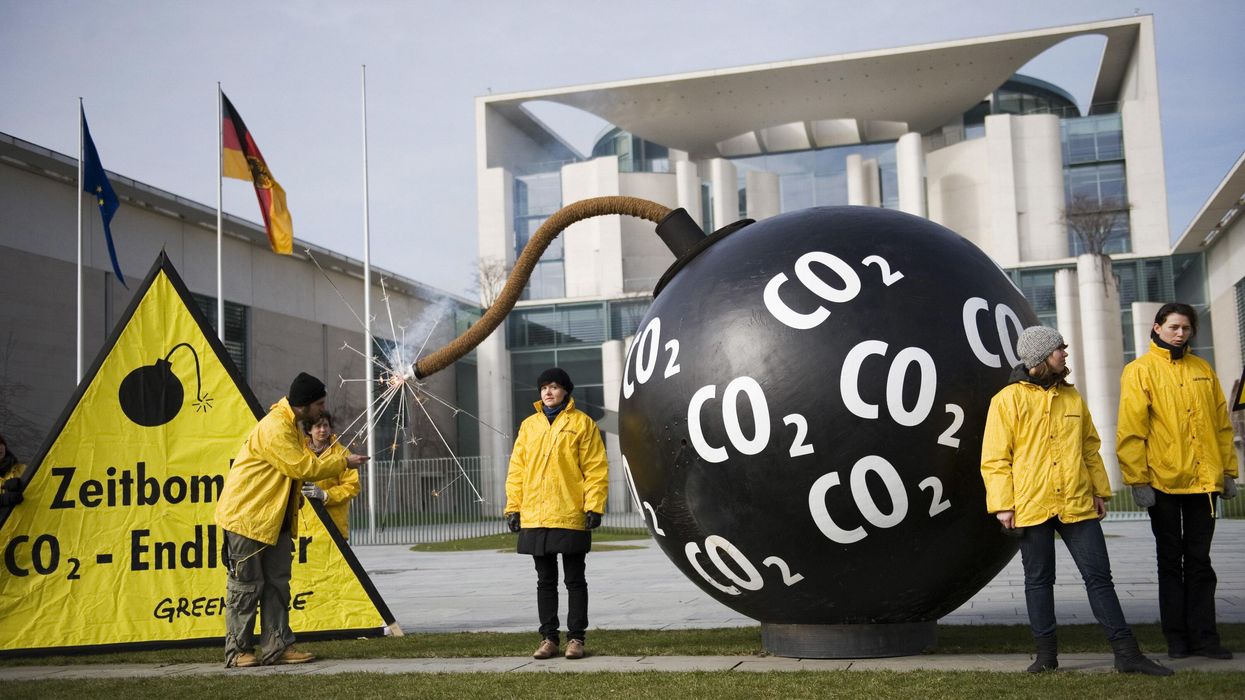 Greenpeace activists in Germany light up a mock bomb to protest carbon capture and storage