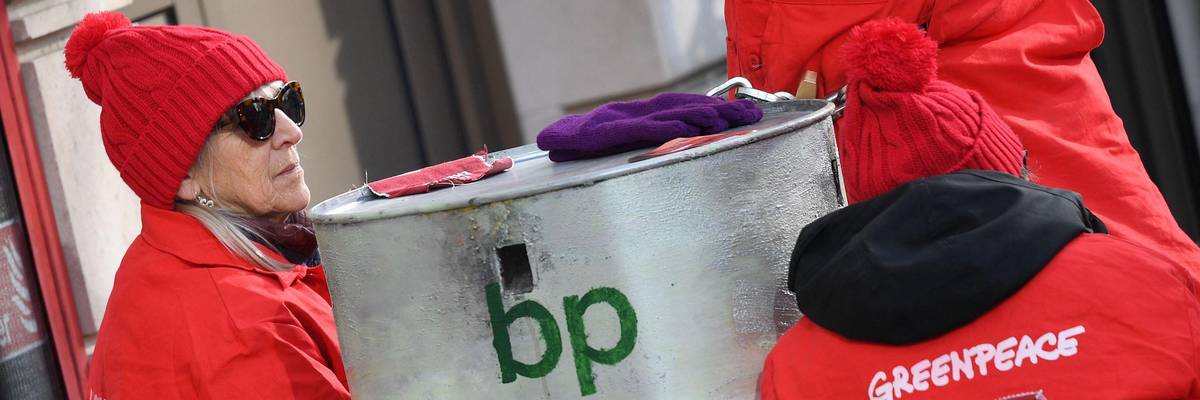 Greenpeace activists sit chained into oil barrels as they protest outside the headquarters of oil giant BP in London on February 5, 2020, on the day that the company's new CEO, Bernard Looney, was set to take up his role. (Photo: Daniel Leal/AFP via Getty Images)