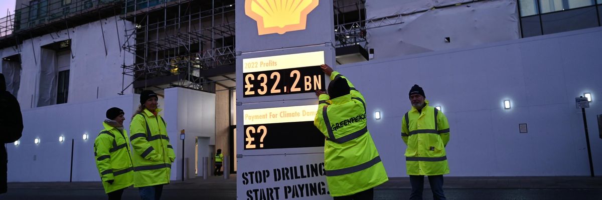 Greenpeace campaigners set up a mock gas station price board outside of Shell's London headquarters