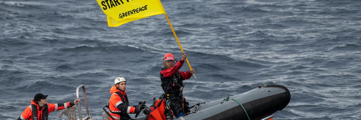 Greenpeace climate justice activists approaching a Shell platform by boat