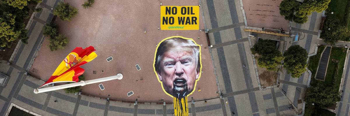 Greenpeace Spain activists displayed a giant image of US President Donald Trump vomiting oil