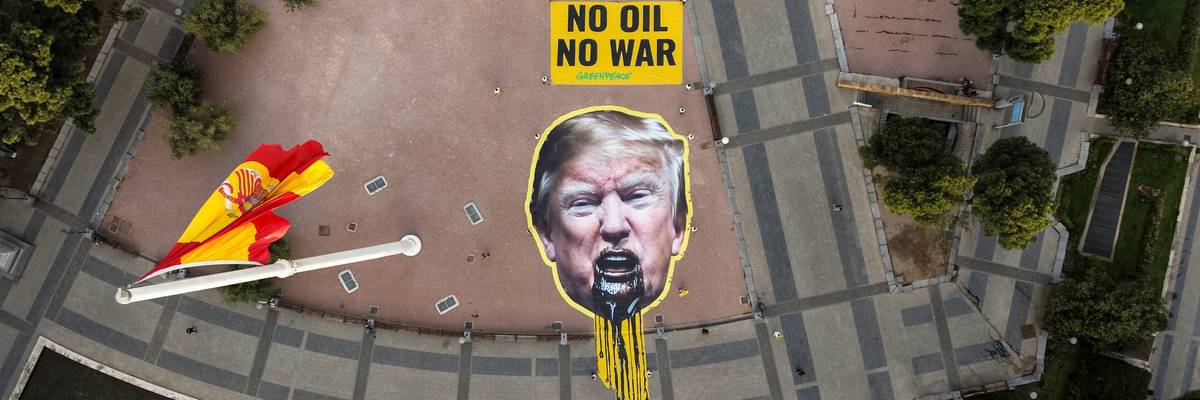Greenpeace Spain activists displayed a giant image of US President Donald Trump vomiting oil